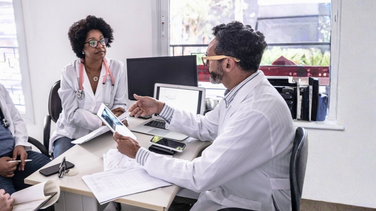Doctor holds space for his colleagues during a stressful clinic day. He has taken a pause and now responds on purpose.